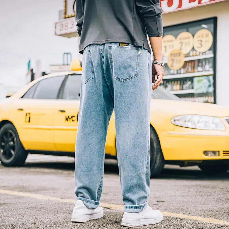 Men's loose fit straight leg casual jeans in dark blue, shown on a hanger.