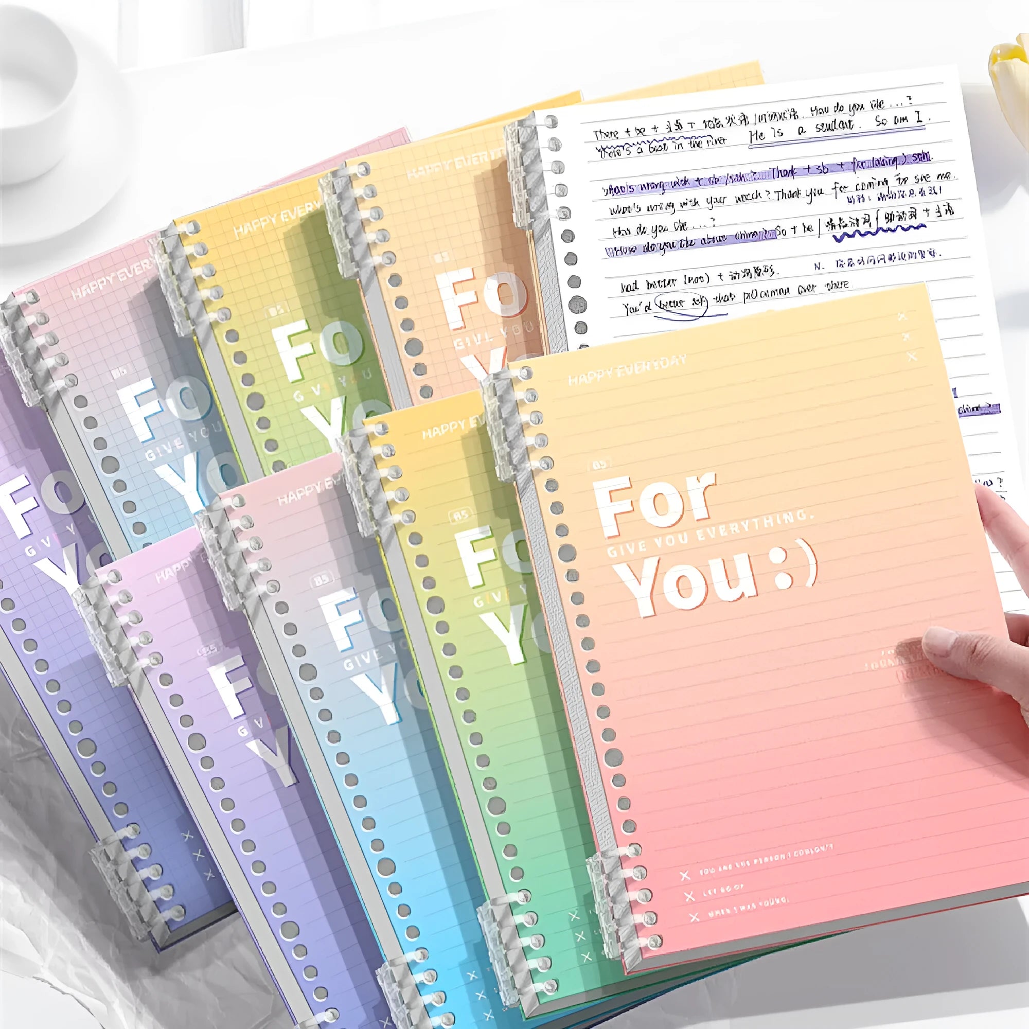 Removable coil notebook with gradient PP cover in green blue pink and purple showing wood-free paper pages