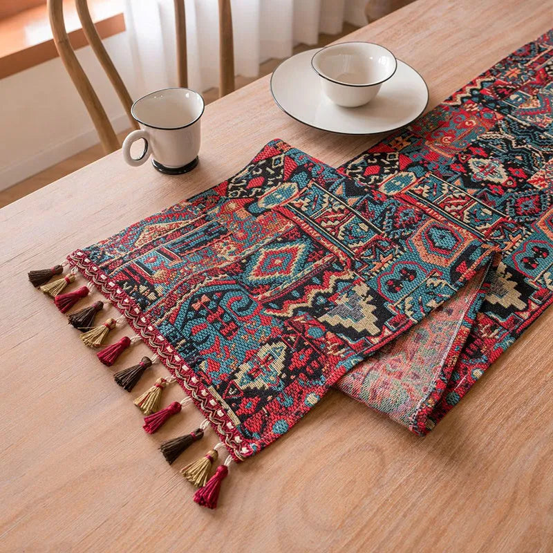 Rhyme Nordic jacquard table runner with tassel trim in a striped pattern, laid flat on a wooden table.
