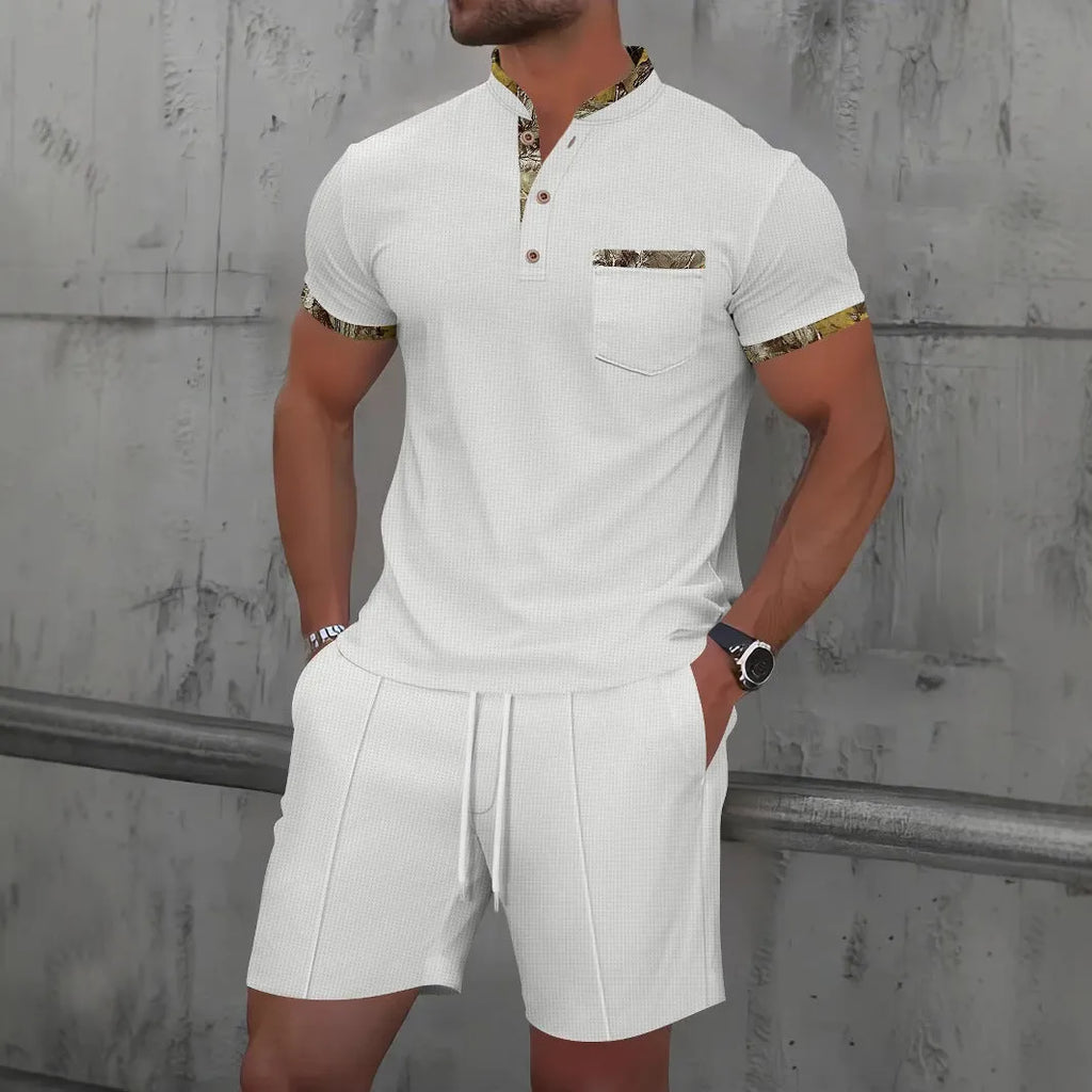 Man wearing a grey short sleeve zippered polo top and matching shorts, a casual cotton blend suit set.