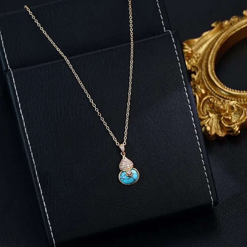 Turquoise gourd flower shape earrings and necklace set on display showing 18K gold plated brass finish