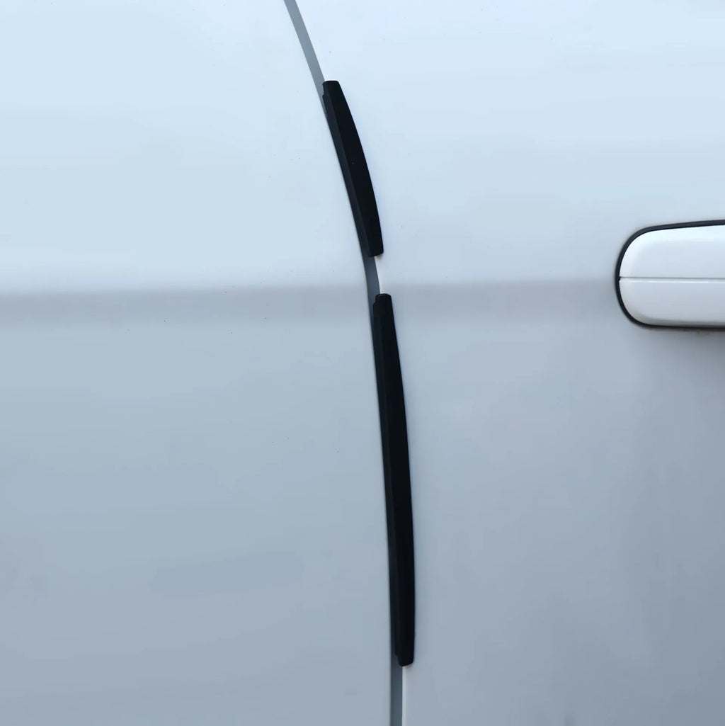 White plastic car door edge protection bumper strip on vehicle.