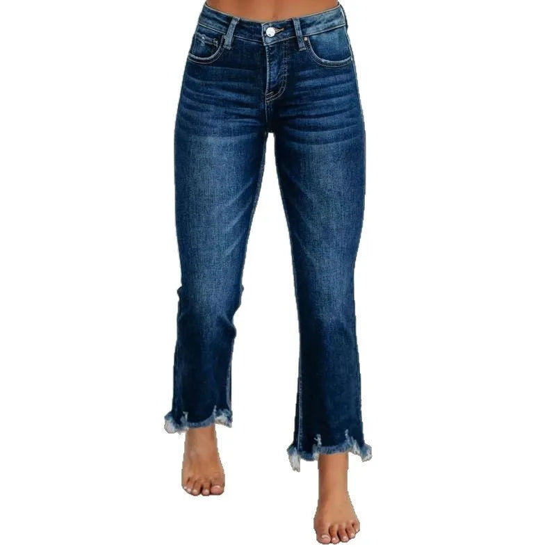 Women's dark blue denim jeans with hand-worn distressing detail on a hanger.