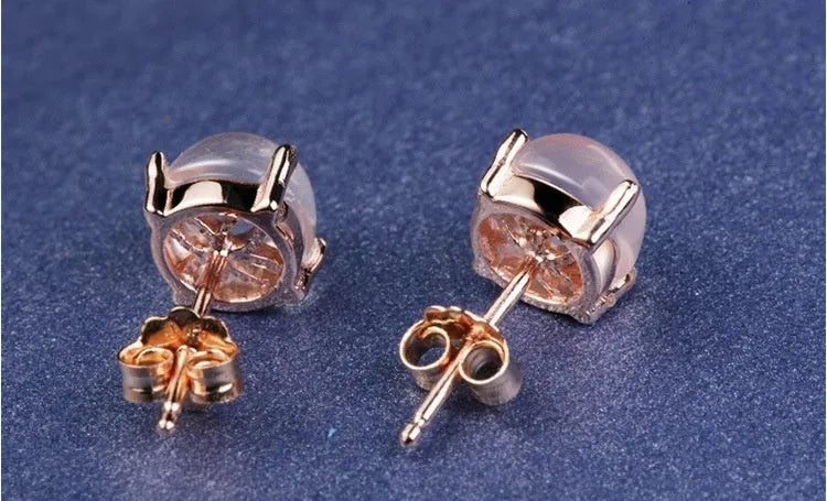 Women's rose gold plated stud earrings with a drop-shaped synthetic rose quartz stone.