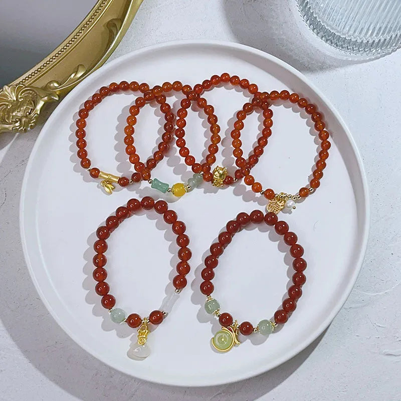 A red agate bracelet for women with a manual crafted dragon design in Chinese style.