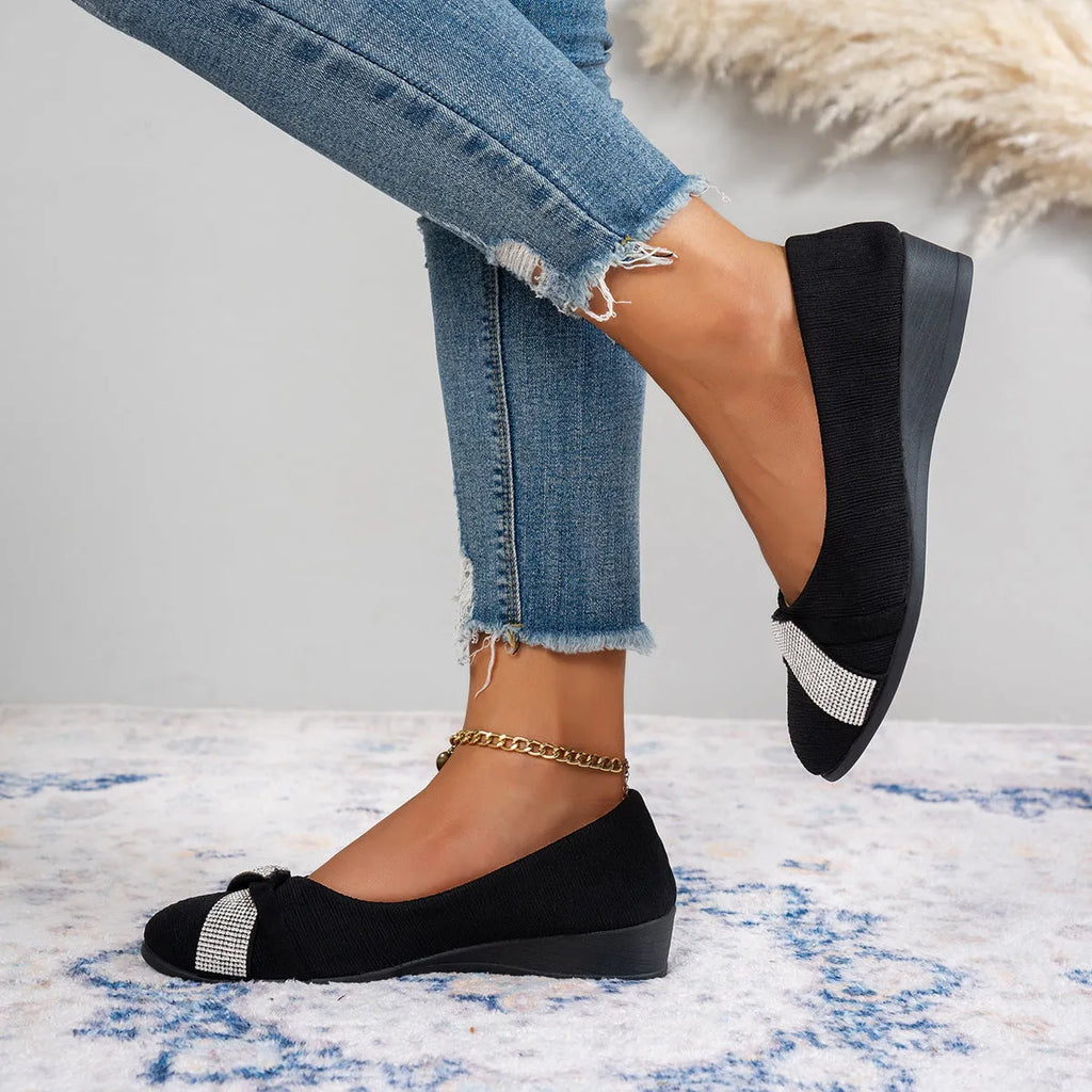 Black women's slip-on casual shoes with rhinestone detail on fabric upper and a short chunky heel.
