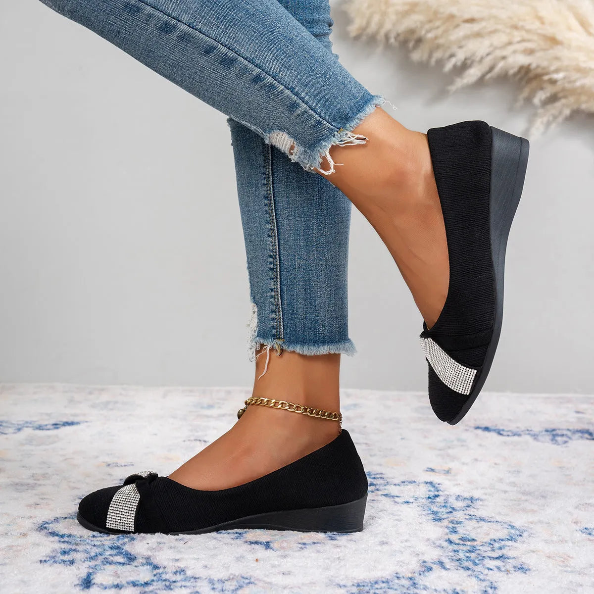 Black women's slip-on casual shoes with rhinestone detail on fabric upper and a short chunky heel.