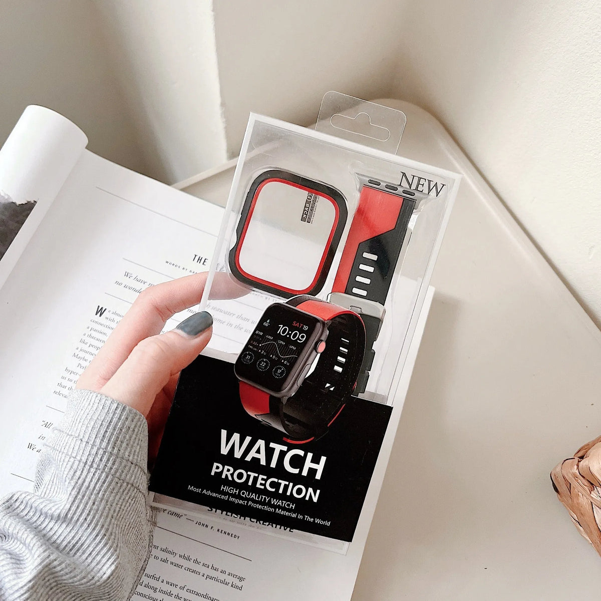Two-tone silicone protective case for Apple Watch in black and white, fitted on a watch face