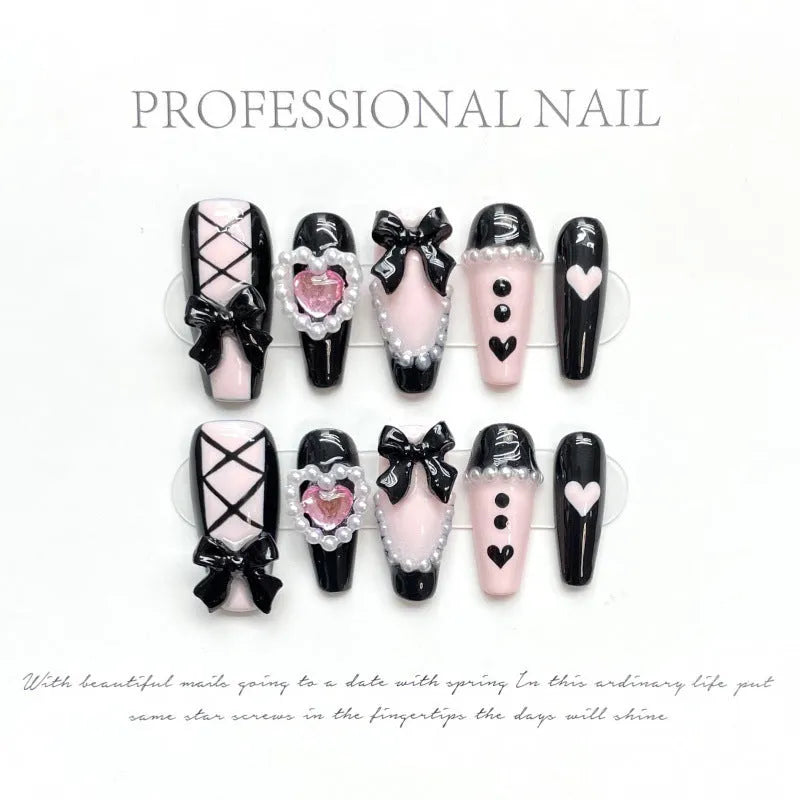 Hand-painted black peach heart artificial nails with bow design in four sizes