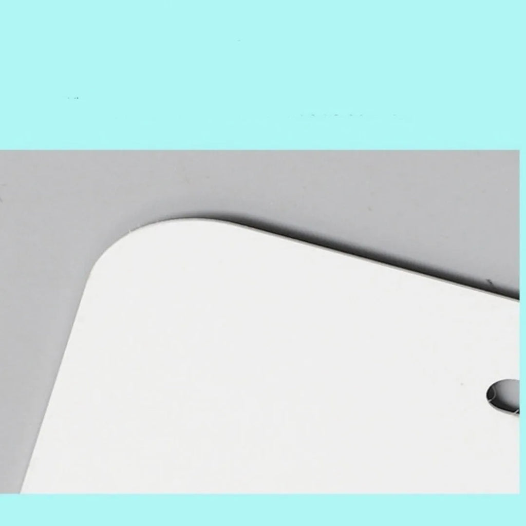A single white rectangular aluminium licence plate blank metal sheet on a grey background.