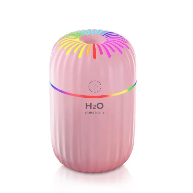 White USB mini humidifier with 300ml water tank on wooden desk next to laptop