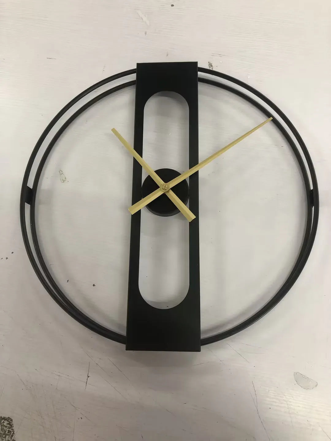 50 cm round metal wall clock on a wall in black and gold colour options