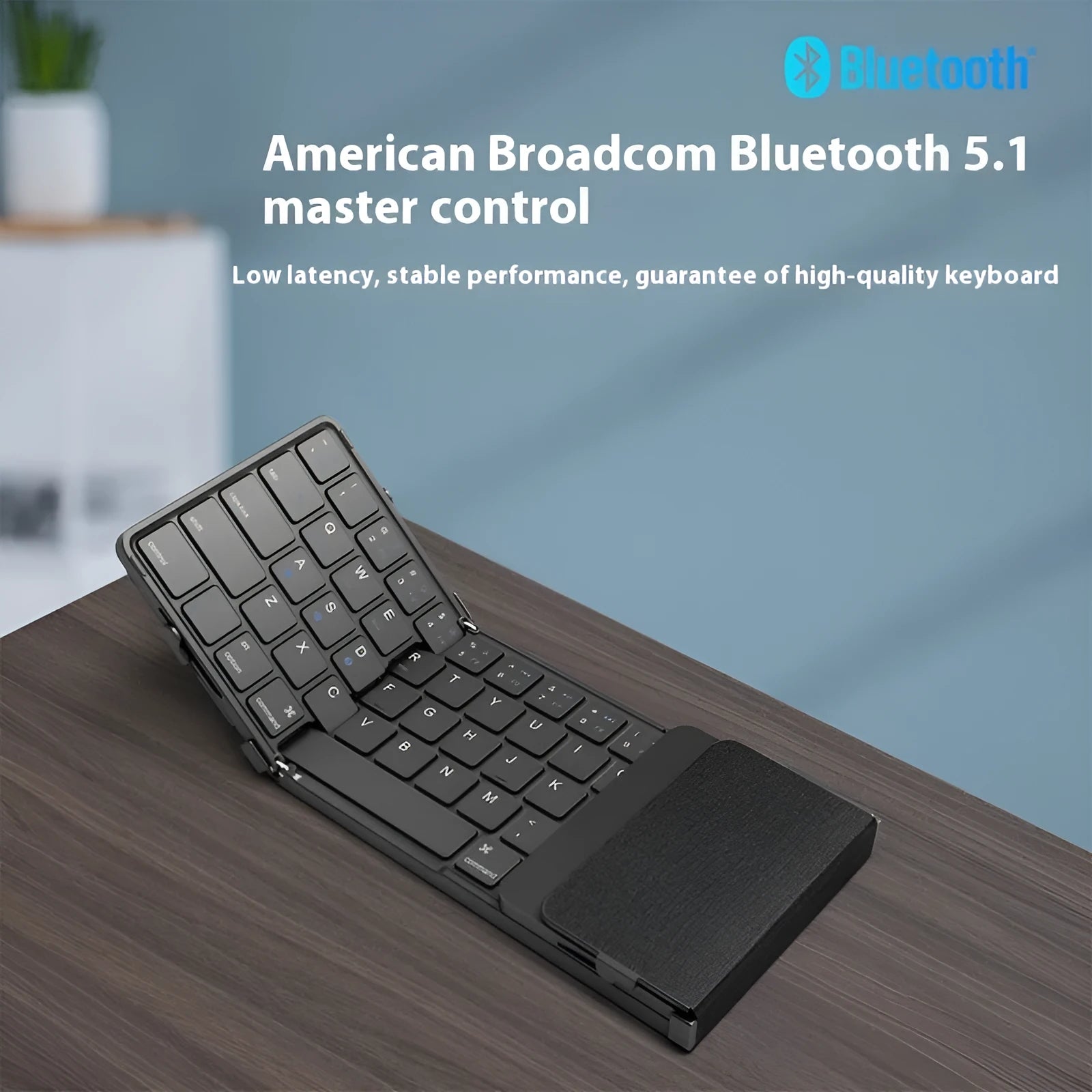 Black folding Bluetooth keyboard for mobile phones and tablets showing compact folded design