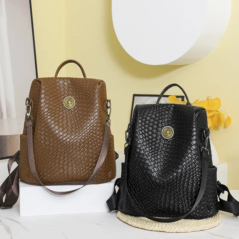 Black women's anti-theft backpack with weaving detail and multiple compartments for travel