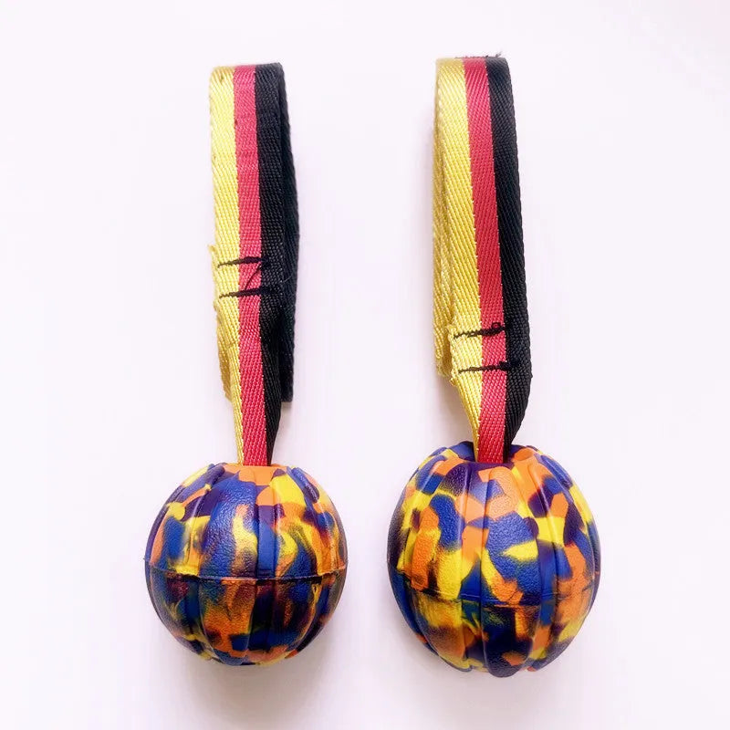 Yellow and camouflage coloured EVA floating knot balls for dogs in three different sizes on a blue background.