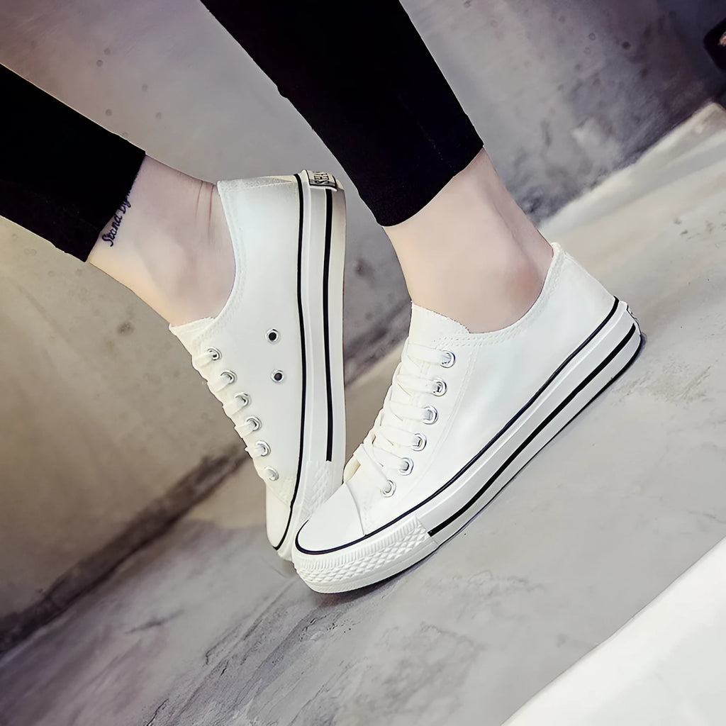 Women's casual lace-up canvas shoes in solid colours on a white background.