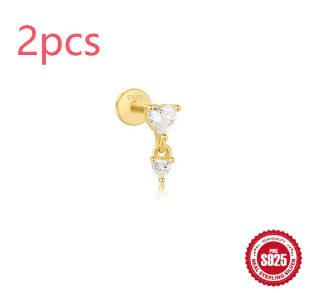 A gold tone sterling silver ear stud featuring a dangling tassel and XINGX inlaid design on the stud.