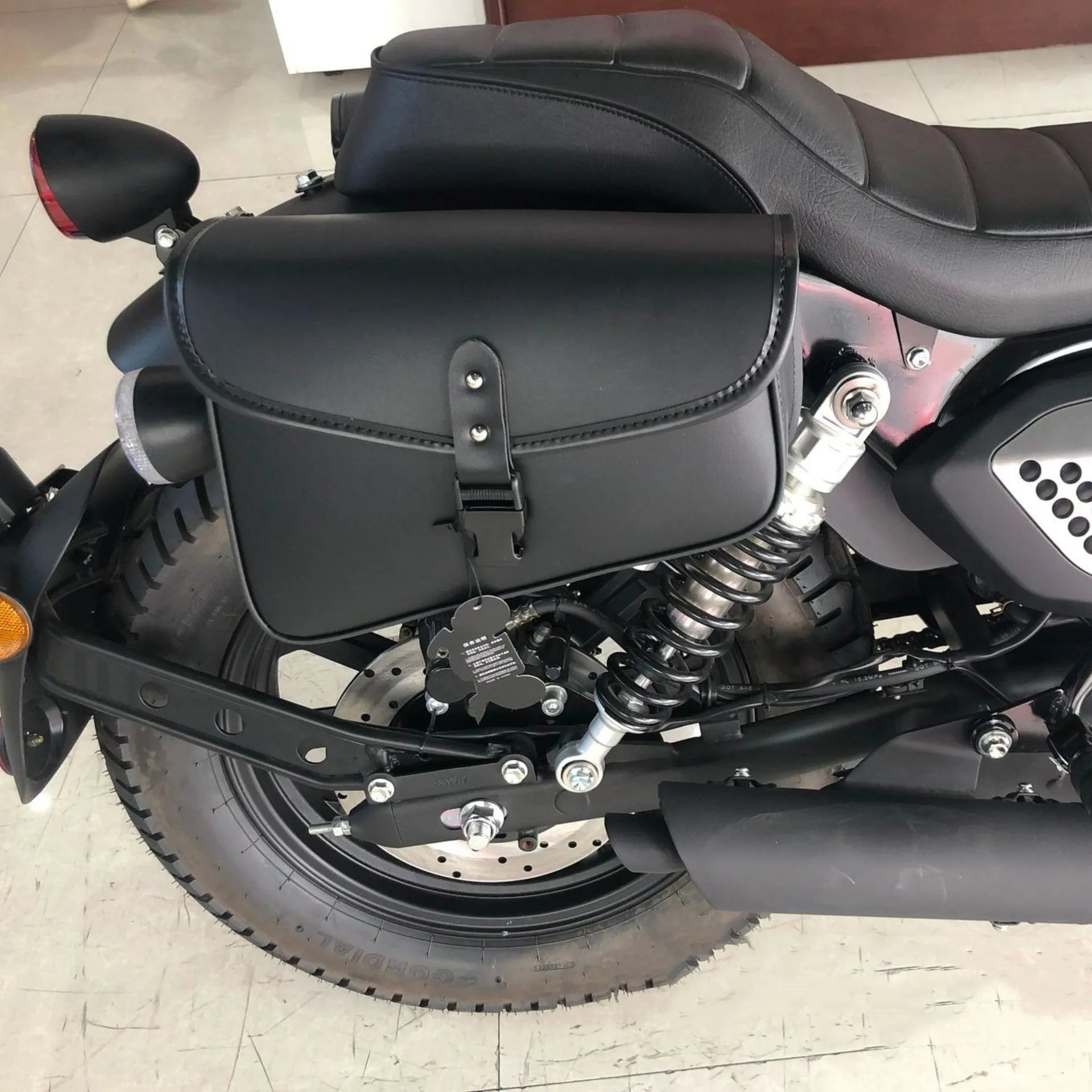 Black PU leather motorcycle swingarm storage bag mounted on Harley-Davidson Sportster showing 30x24x20cm dimensions