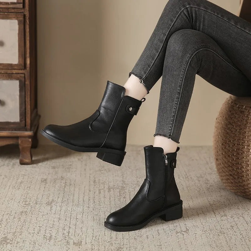 Black women's low heel boots with side zip and round toe on a white background.