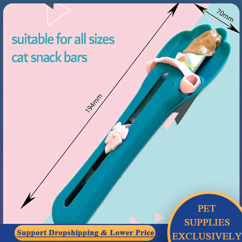 Green and pink pet feed spoon with squeeze mechanism for dispensing liquid food and treats