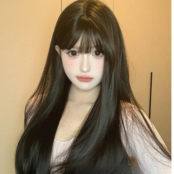 Dark brown long straight synthetic women's wig with a fringe on a wig head.
