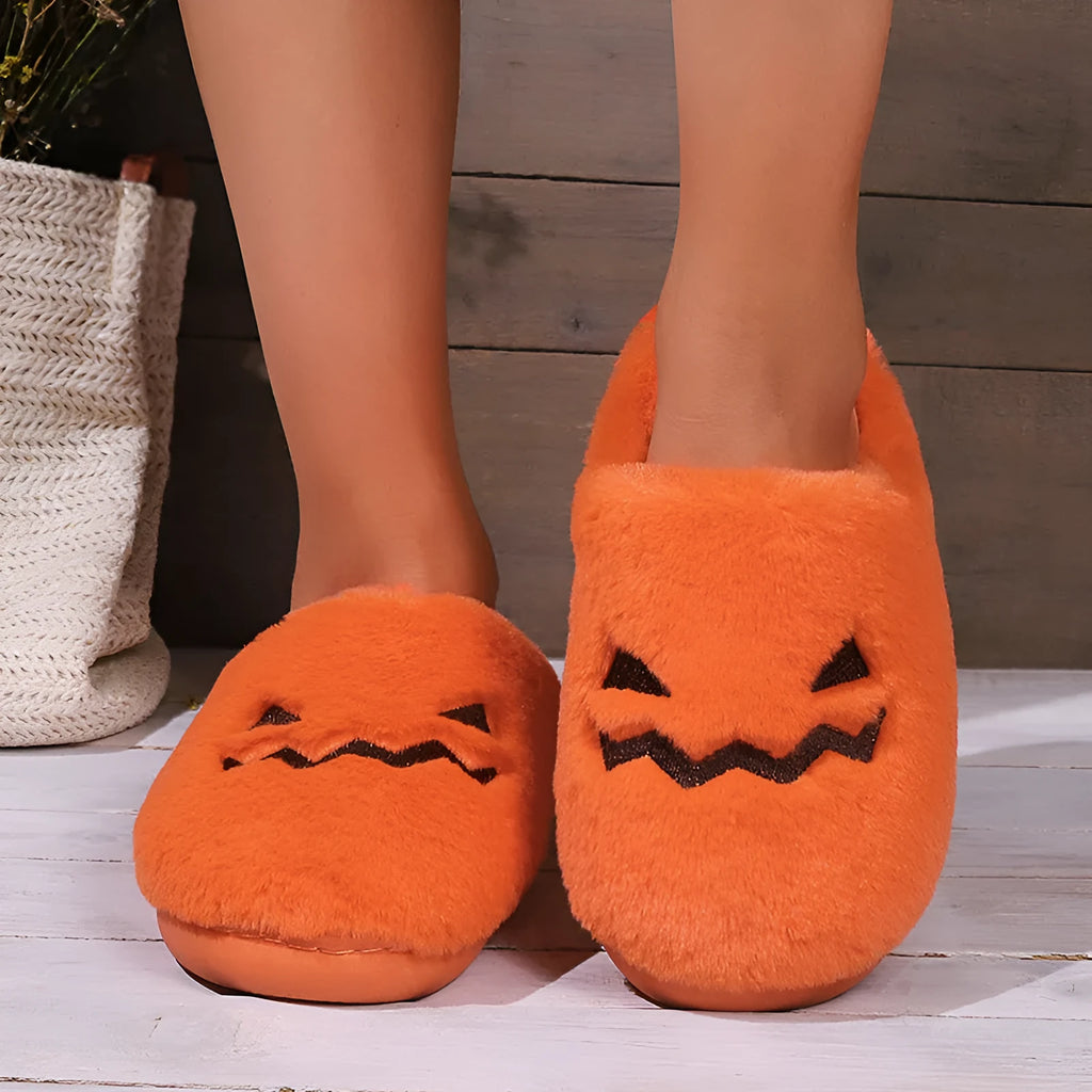 Orange plush Halloween pumpkin slippers with coral velvet upper and flat PVC sole.