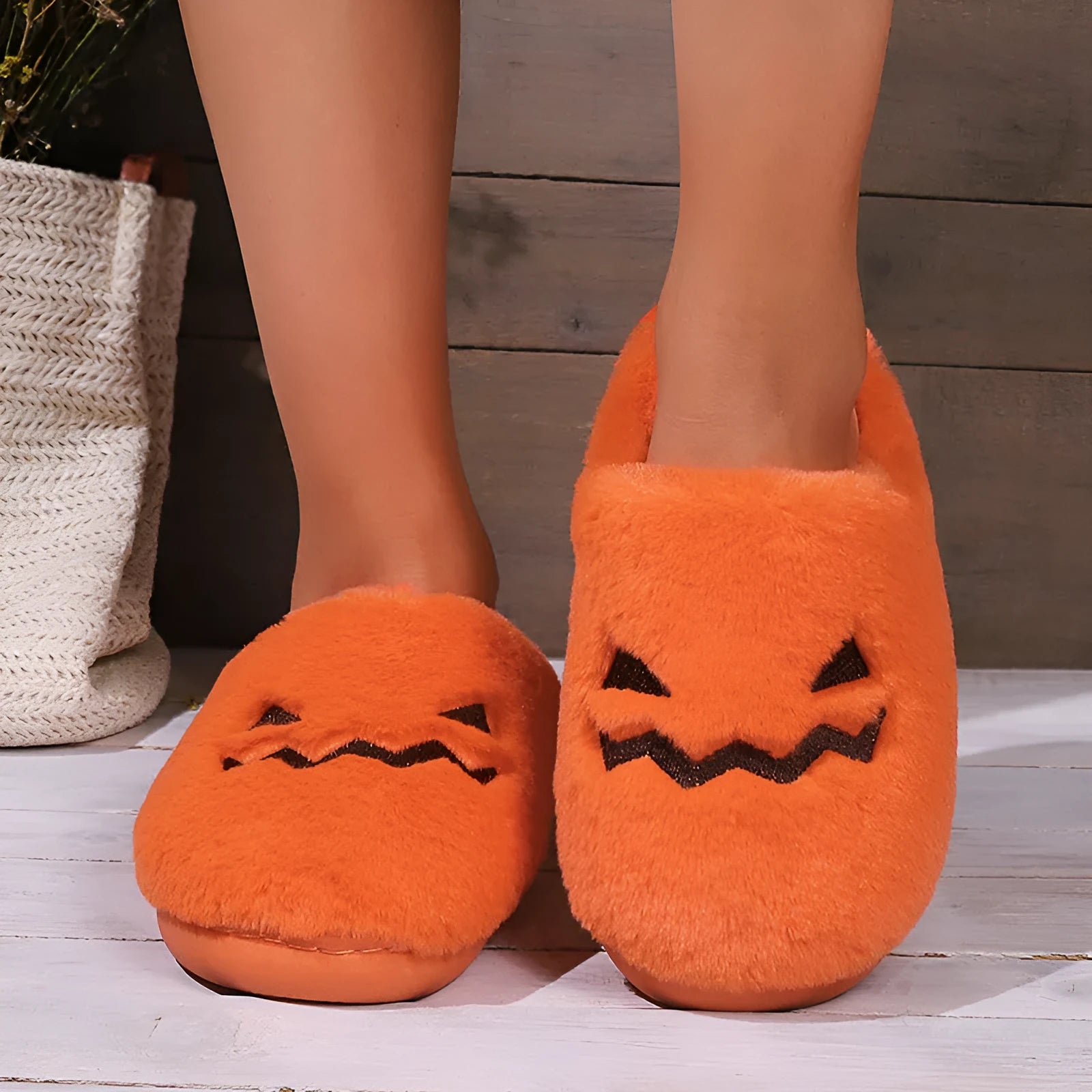 Orange plush Halloween pumpkin slippers with coral velvet upper and flat PVC sole.