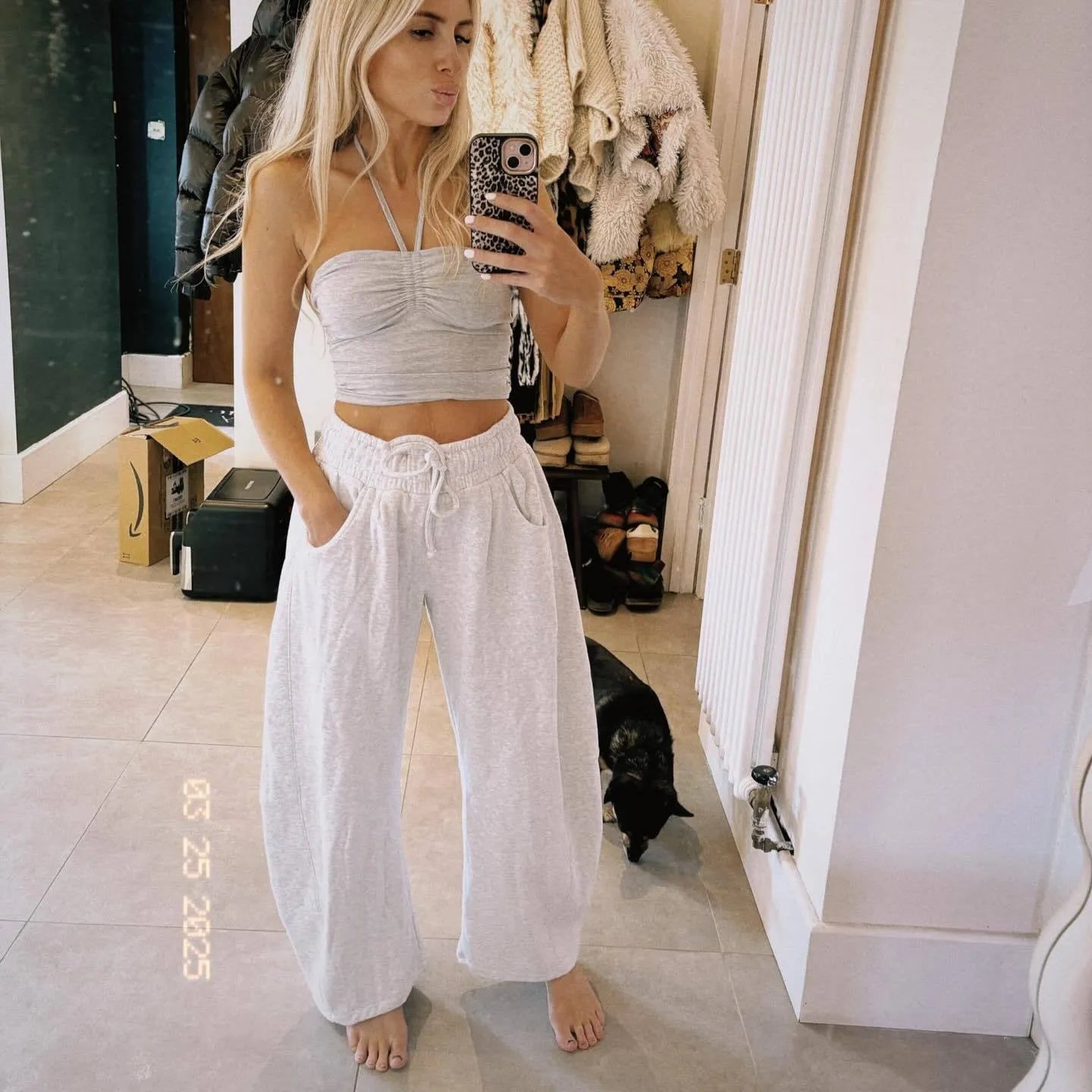 Loose cropped sweatpants with drawstring waist and side pockets in street fashion styling
