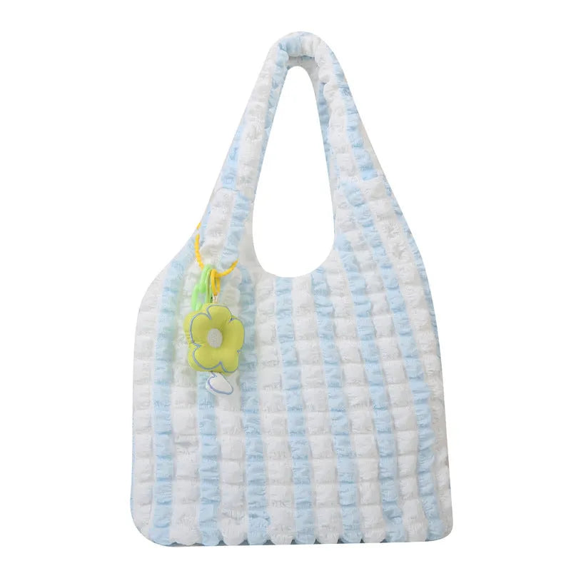 Soft pleated square bubble bag in beige with a removable pendant and single shoulder strap.