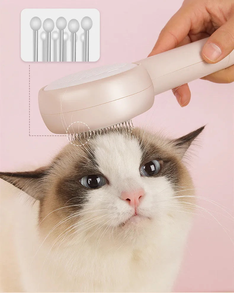 Pink cat combing brush floating needle comb for cats and dogs on white background