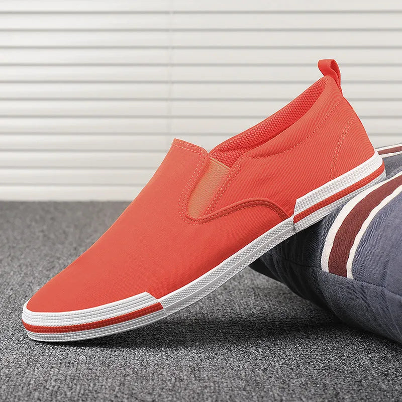 Men's low-top casual canvas shoes in grey, black orange, or khaki with vulcanised rubber soles.