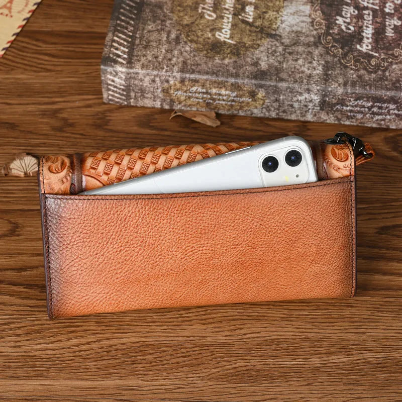 Women's embossed floral tri-fold leather wallet in retro brown colour showing cowhide texture and organisational compartments.