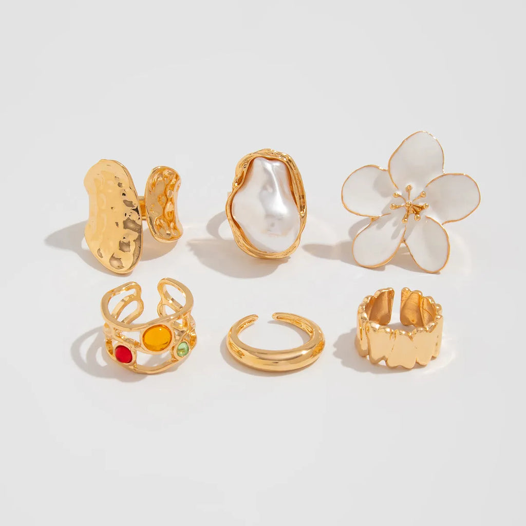 Women's open ring with liquid lava flower design, imitation pearl detail, available in gold or silver