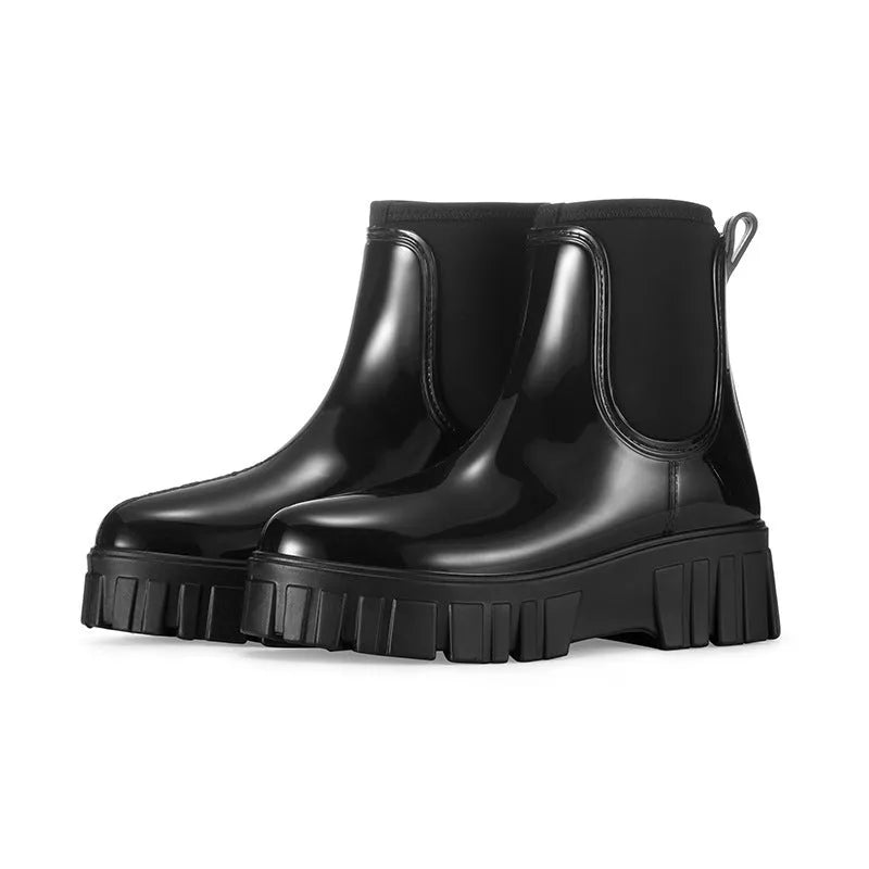 Creamy-white low tube PVC rain boot with non-slip sole on a wet surface.
