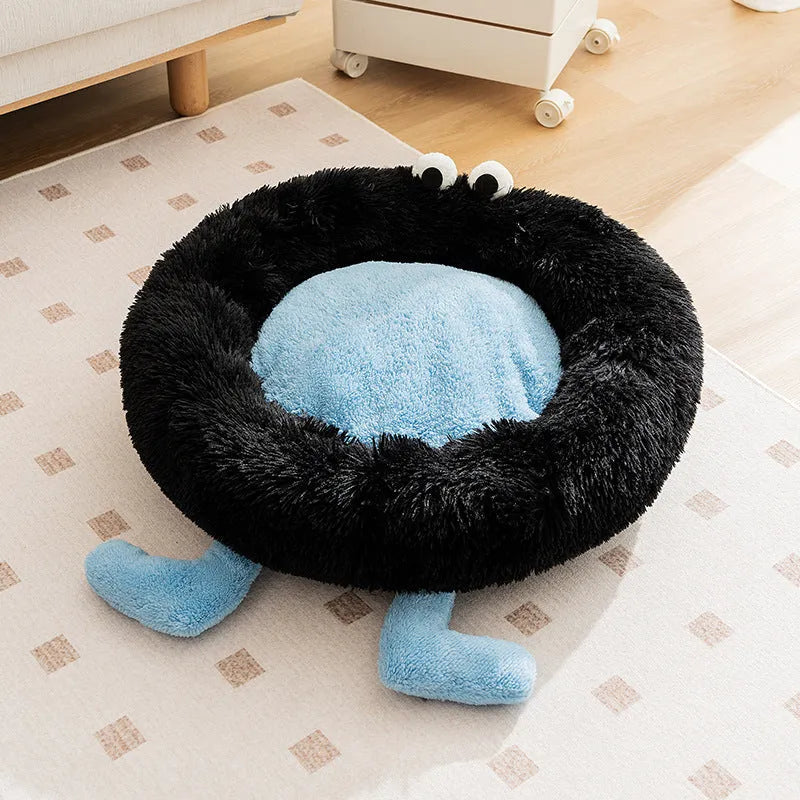Blue Elf Briquettes plush kennel pet bed with raised bolster edge for dogs or cats, shown in a home setting.