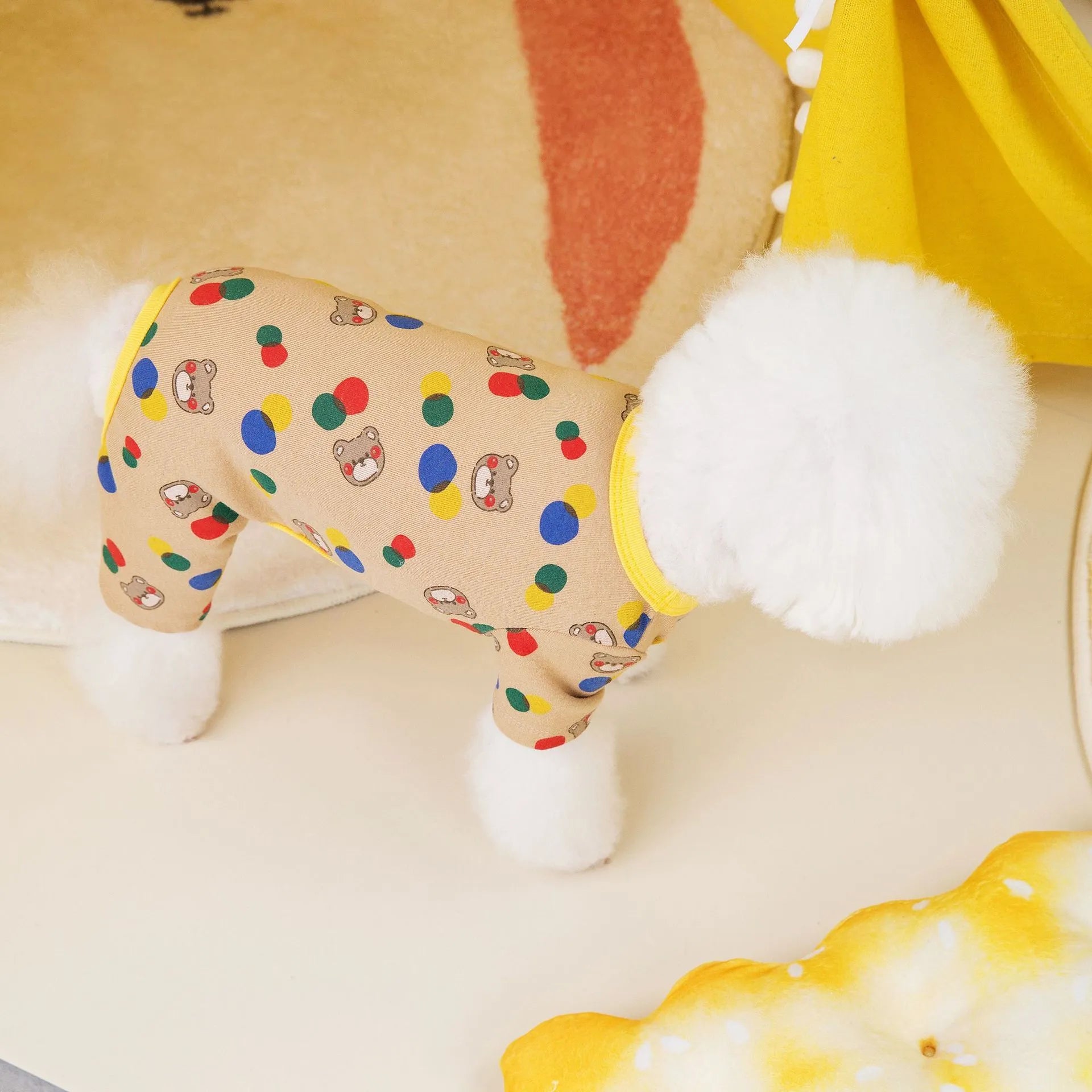 Beige dog jumper with colourful ball bear print, made from cotton and spandex.