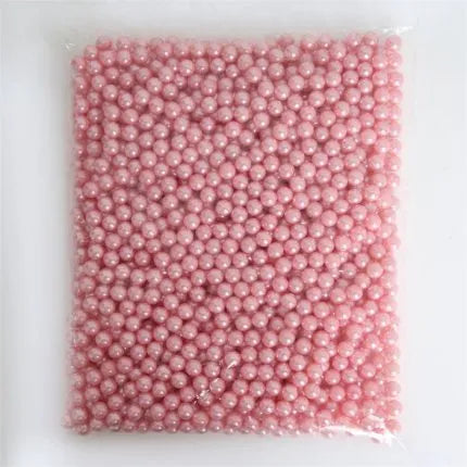 Clear acrylic makeup brush holder on a countertop with pearl coloured beads inside, measuring 12.3x10.6x21.5cm