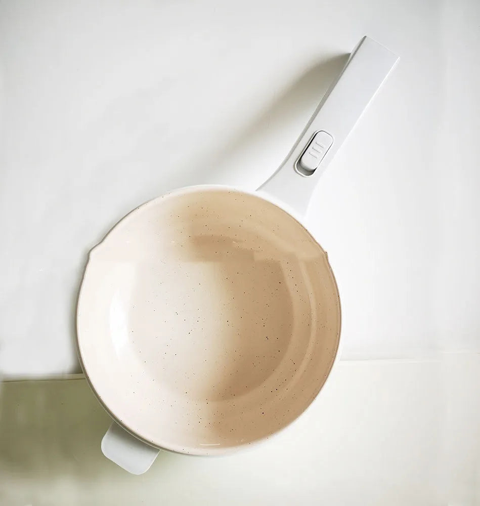 White electric cooking pot with 20cm mouth, 7cm depth, 700W mechanical control, on a dormitory desk