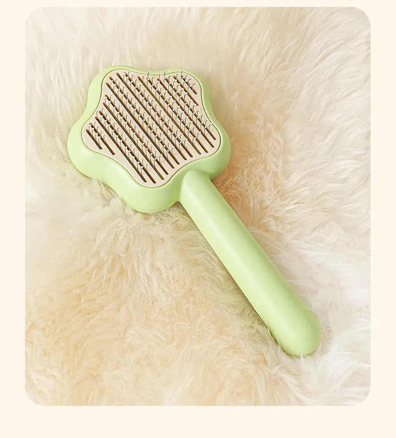Magic wand cat comb with stainless steel needle teeth and self-cleaning mechanism in green colour