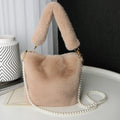 Plush bucket bag with gold-toned pearl chain on a beige background