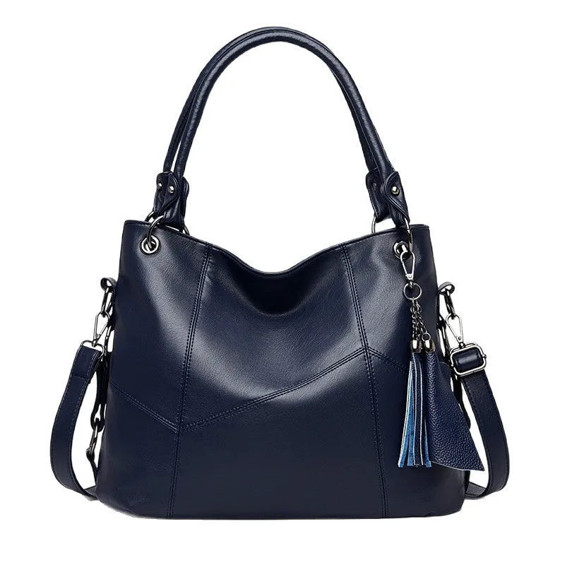 Large capacity PU tassel handbag in black, front view with tassel detail