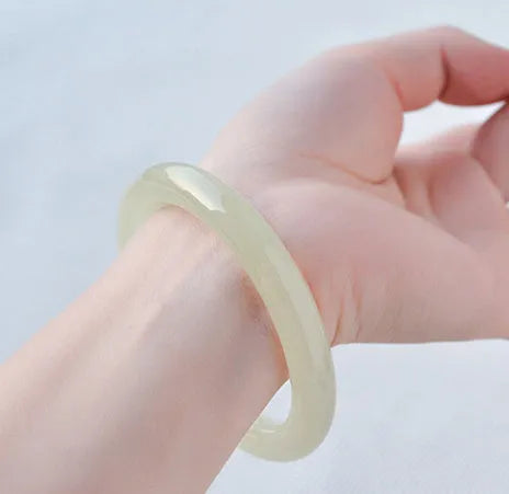 Adjustable winding bracelet made of round ice-like silk jade beads on a silk cord.