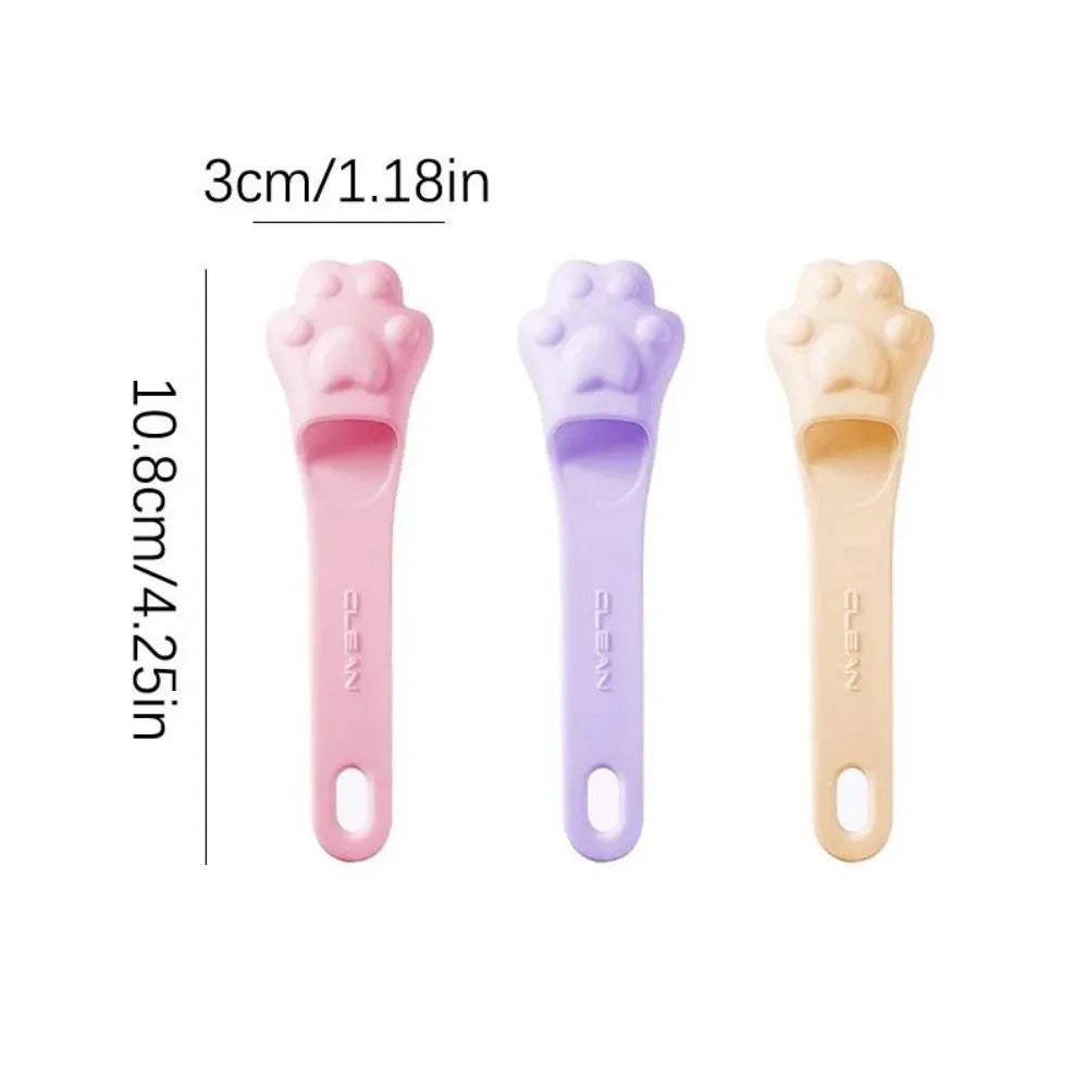 Silicone finger cover toothbrush for pet dental cleaning in pink, purple, and yellow colours.