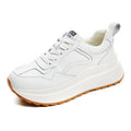 Women's beige cowhide leather casual sports shoes with round toe and cross-strap detail.