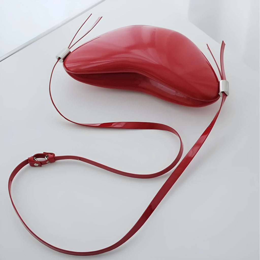 Red heart shaped crossbody bag in solid PU synthetic leather with single shoulder strap and sandwich pocket