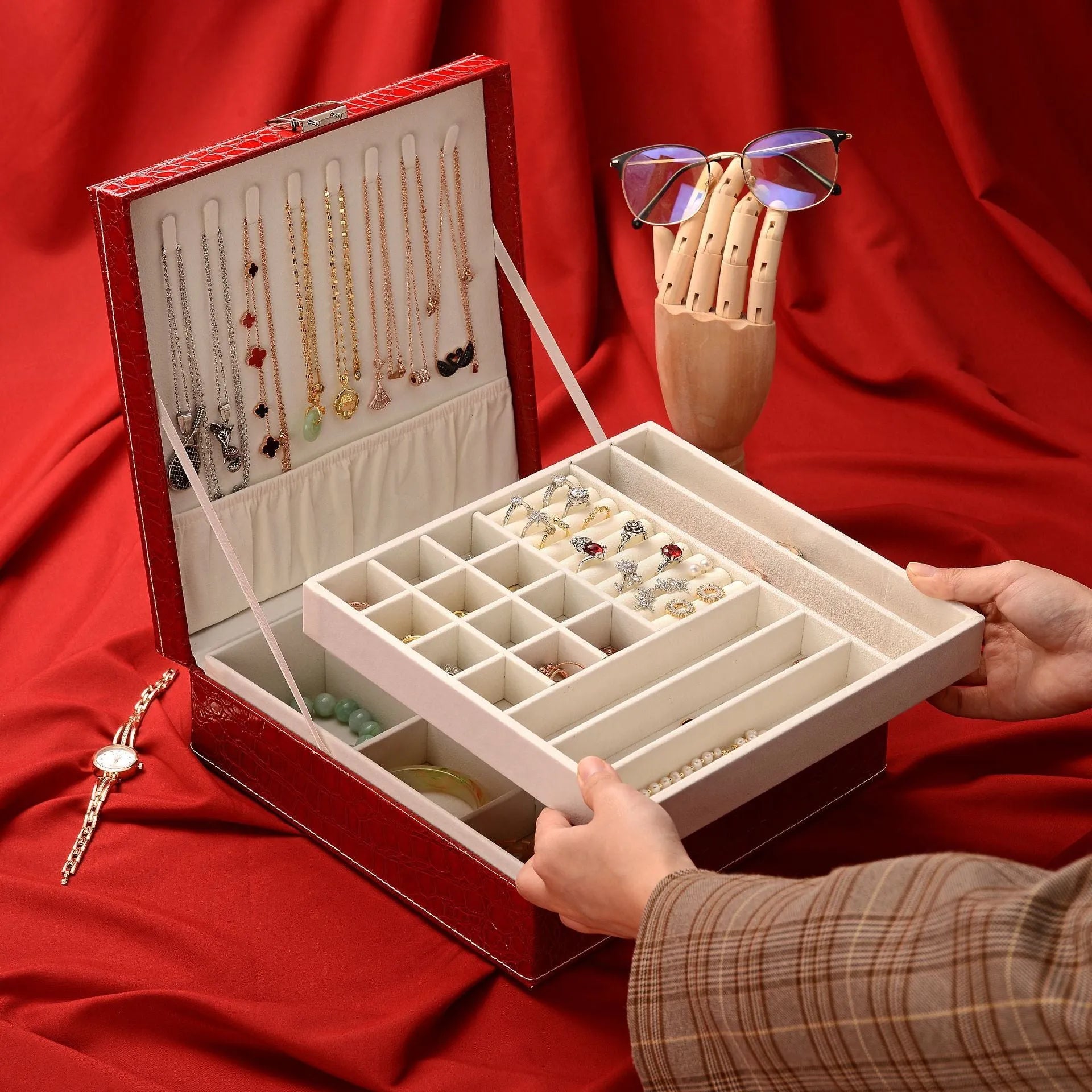 Green leather jewellery storage box with crocodile pattern, lock, and open double-layer interior.