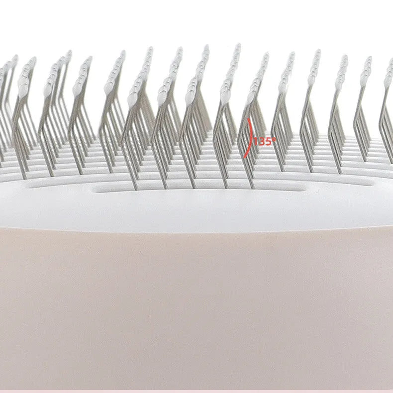 Pink cat combing brush floating needle comb for cats and dogs on white background