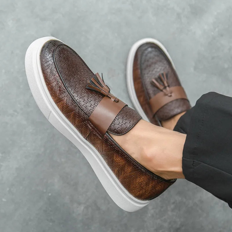 Men's black casual fringed leather shoes with a low heel and round toe on a white background.