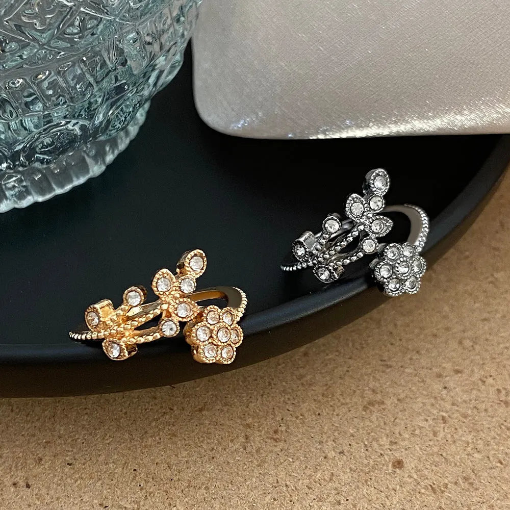 Women's diamond flower leaves open ring in gold and white colour options showing floral design