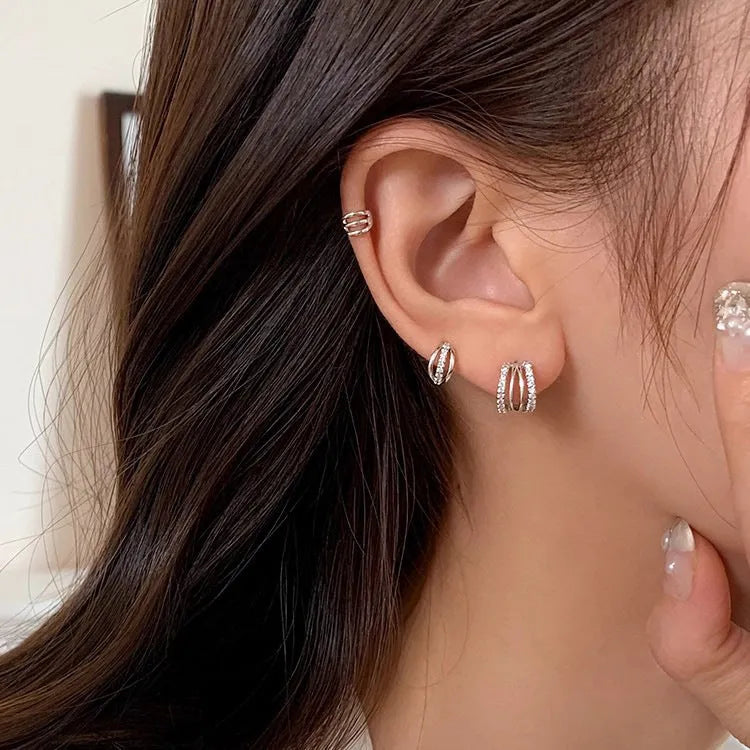 A pair of geometric-shaped earrings made from 925 silver needle with an electroplated finish.